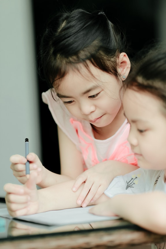 A girl is smiling with tablet in hand